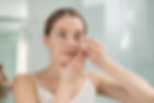 woman applying contact lenses