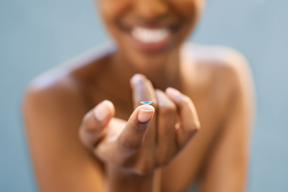 Woman holding contact lens in hand