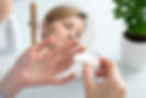 woman holds a contact lens