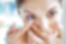 Woman applying contact lens