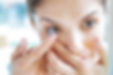 woman applying contact lens