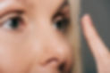 close up of a woman applying contact lenses