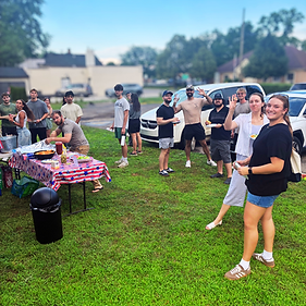 young adults eating and waving outside