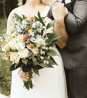 elaborate bridal bouquet with bride and groom