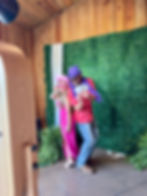 Two guests posing with props at a Gulf Shores Photo Booth Co. booth.