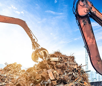 Two excavators loading scrap metal