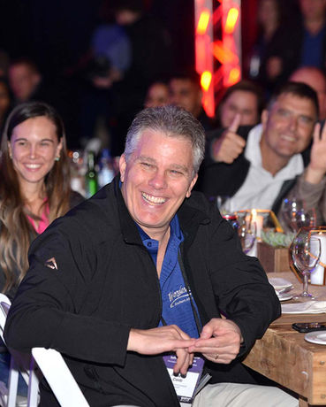 Smiling man with friends at a lively event