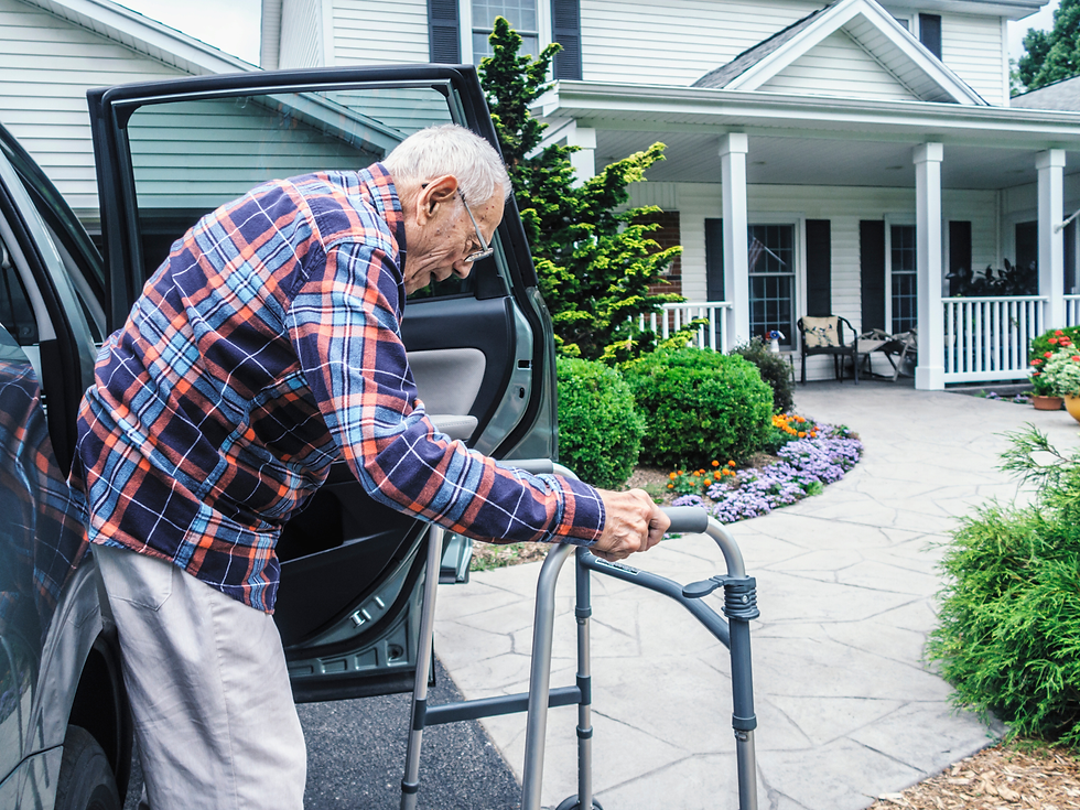 Man getting out of car with a walker