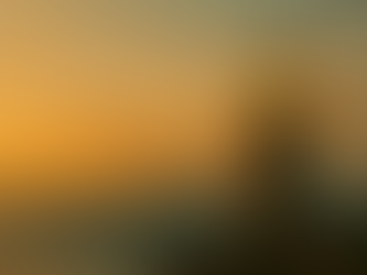 Lighthouse glowing at sunset over calm ocean — symbolizing guidance, clarity, and creative direction