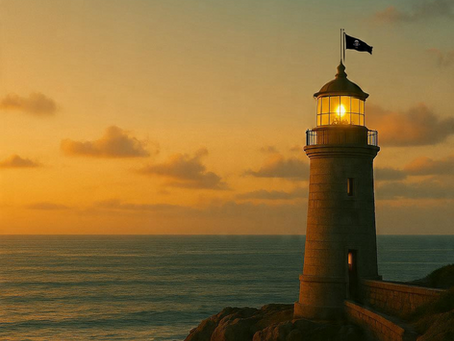 Lighthouse glowing at sunset over calm ocean — symbolizing guidance, clarity, and creative direction