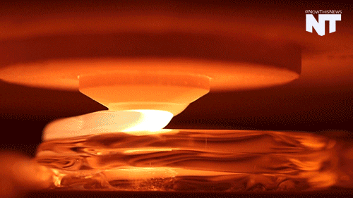 A 3D printer creates a clay pot under warm amber light. The printer head moves smoothly, crafting delicate layers.