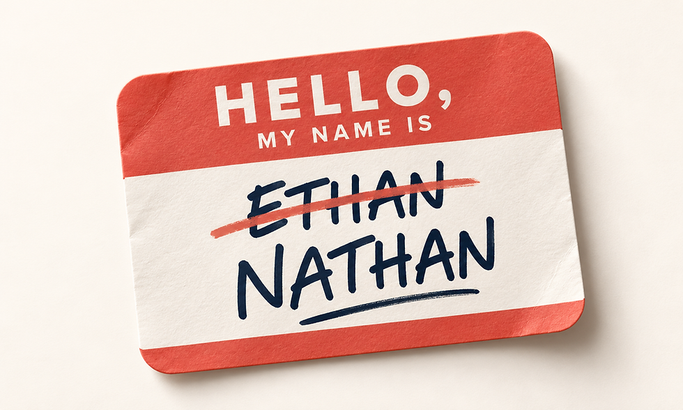 A nametag with "Hello, my name is Ethan" written in black texta. The name Ethan has been crossed out and replaced with the name Nathan..