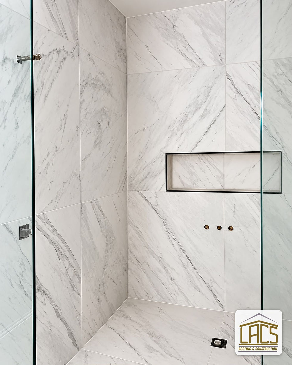 Bathroom remodeling with marble walk-in shower by LACS Roofing & Construction in Central Florida