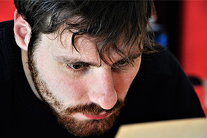 Stressed man looking at computer screen.