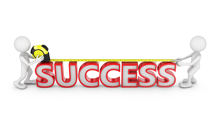 Two people measuring the word success.