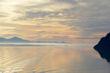 alaska ocean sunrise cloudy sky water mountains waves reflection pink peach landscape photograph