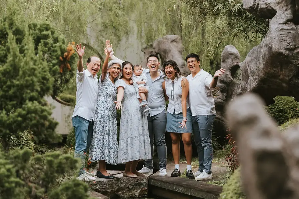 Family posing near flowers and greenery during Singapore family photography at gardens by the bay chinese 