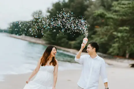 outdoor maternity casual carefree photoshoot using bubble guns at changi beach singapore