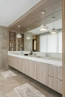 Bathroom with floating vanity, stone countertop, and warm ambient lighting.
