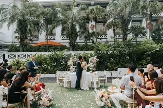 Groom dips bride for a kiss along the aisle of garden wedding solemnisation at METT Singapore Hotel Fort Canning.
