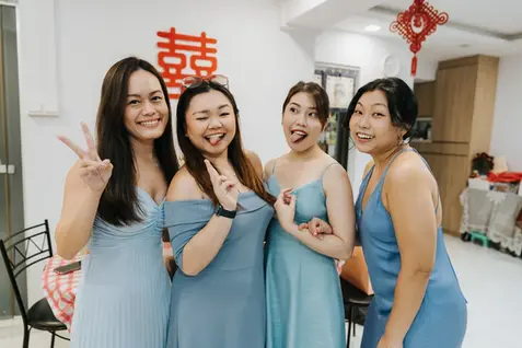 Four bridesmaids in blue dresses posing at wedding.
