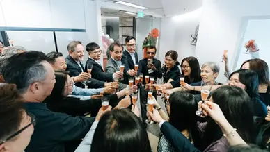 Champagne toasting  and guests at AIT Worldwide Logistics office opening at The Gateway West Singapore.