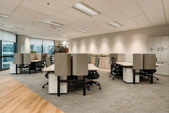 Corporate workspace with integrated workstations and minimalist interior finishes.