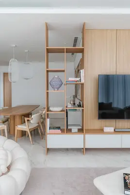 Bright dining space featuring white furnishings and warm timber detailing.