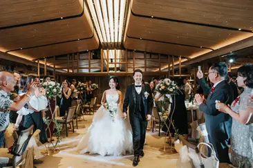 Bride and groom walking down aisle during wedding march-in at Singapore Park Royal Marina Bay wedding banquet.
