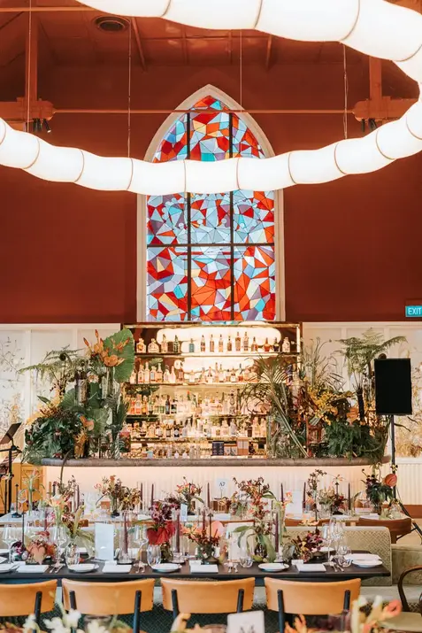 Wedding reception at Claudine with stained glass backdrop