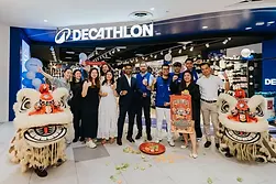 Decathlon team with lion dancers at a branding event.