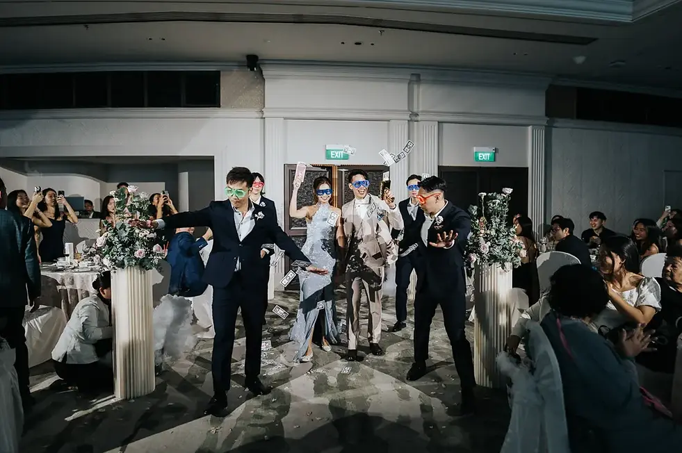 Bride and groom energetic mafia march-in with entourage during wedding celebration at Mandarin Oriental Singapore banquet.