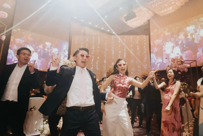 Bride, groom and bridal party enjoying fun dancing moments together at Sheraton Towers Singapore