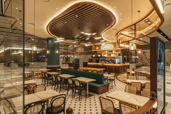 Interior of Roost Restaurant at Airport Terminal 4 with contemporary dining space and warm lighting.