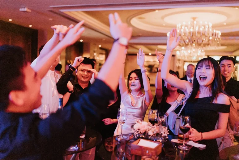 Bride, groom and bridal party enjoying fun moments together at [Venue Name].