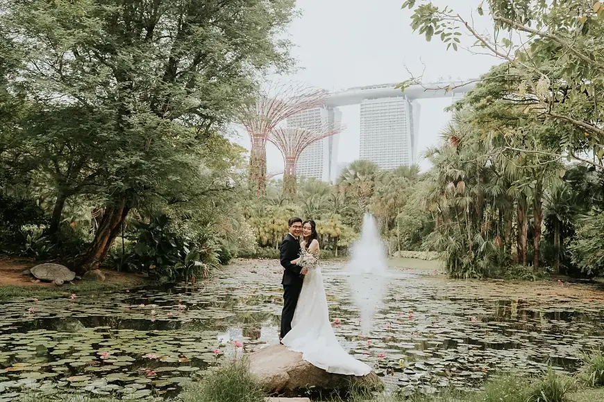 Wedding solemnisation at Gardens by the Bay Singapore with the couple on the iconic floating rock at the Lily Pond, featuring Marina Bay Sands and Supertrees in the background.