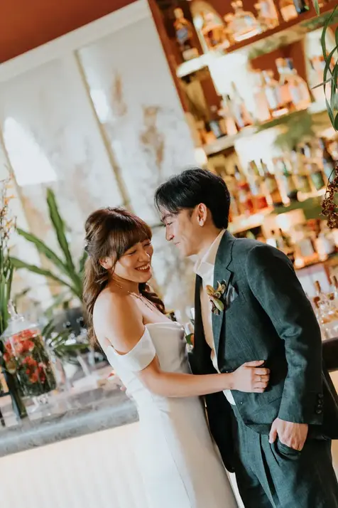 Bride and groom smiling at each other at their wedding