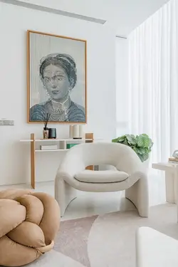 White upholstered sofa paired with a light wood side table.