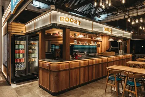 Dining area at Roost Imbia with modern furnishings and ambient lighting.