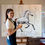 Thumbnail: Artist Danielle Fernandez in her studio in front of her 60x48 inch original horse painting on canvas