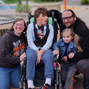 Katelyn posing for a picture with her husband and two children.