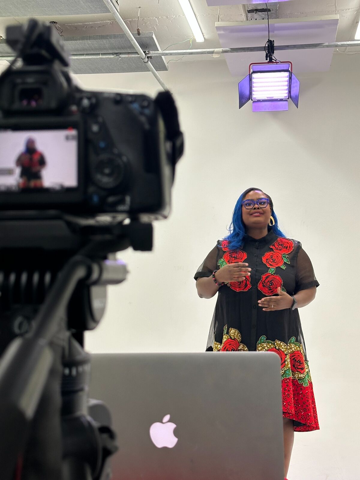 Rita speaking on camera during a presentation