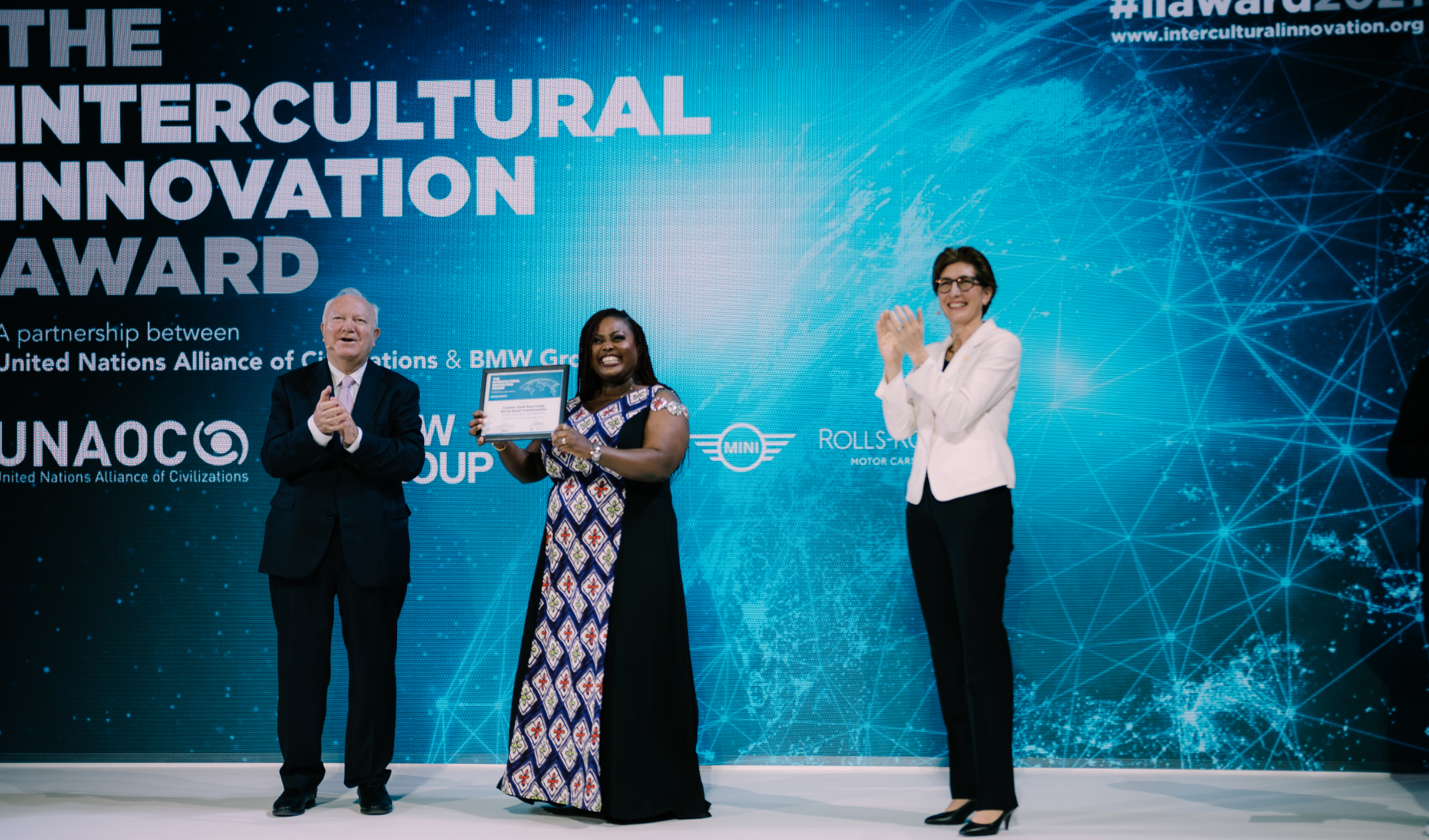 Rita receiving the Intercultural Innovation Award on stage