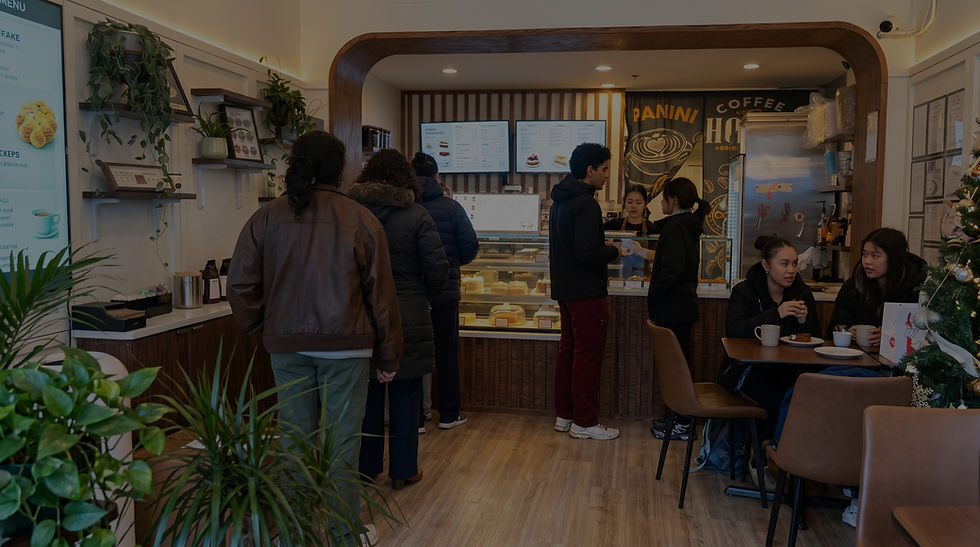 Customers ordering and seated in a busy coffee shop