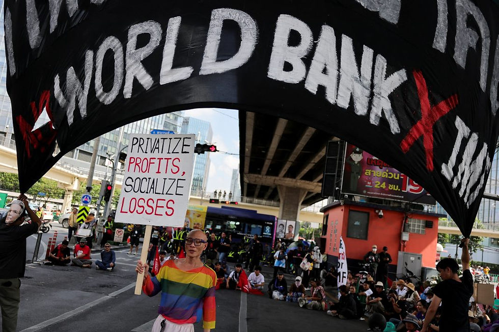People hold a banner as they demonstrate against the World Bank near Queen Sirikit National Convention Center, the venue of IMF/World Bank 2026 Annual Meetings, in Bangkok, Thailand on Oct. 15, 2026. (Credit: Reuters)