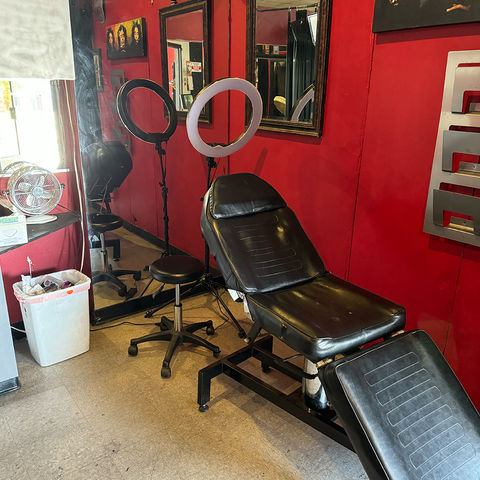 A photo of Jay's working station with a fully reclining chair for all tattoo positions.