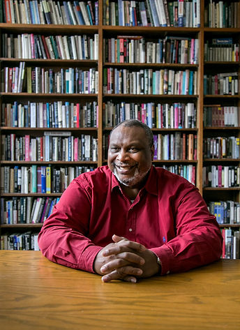 Dr. Quintard Taylor smiling in a library