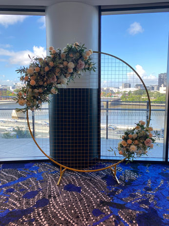 Gold circular mesh stand with autumn faux florals in Studios at W Brisbane for wedding