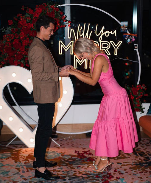 Will you marry me neon sign with backdrop, red rose faux florals, giant light up love heart at W Brisbane Hotel