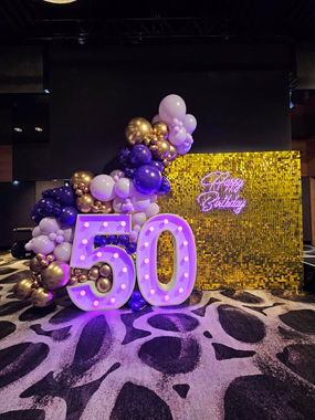 50 light up numbers with gold shimmer wall, Happy Birthday neon sign and balloon garland (purple and gold) at W Brisbane